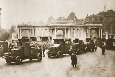 Bus and lorry convoy from the docks to the milk and food dump at Hyde Park escorted by armoured cars during the Great Strike, from Wonderful London, published 1926-27